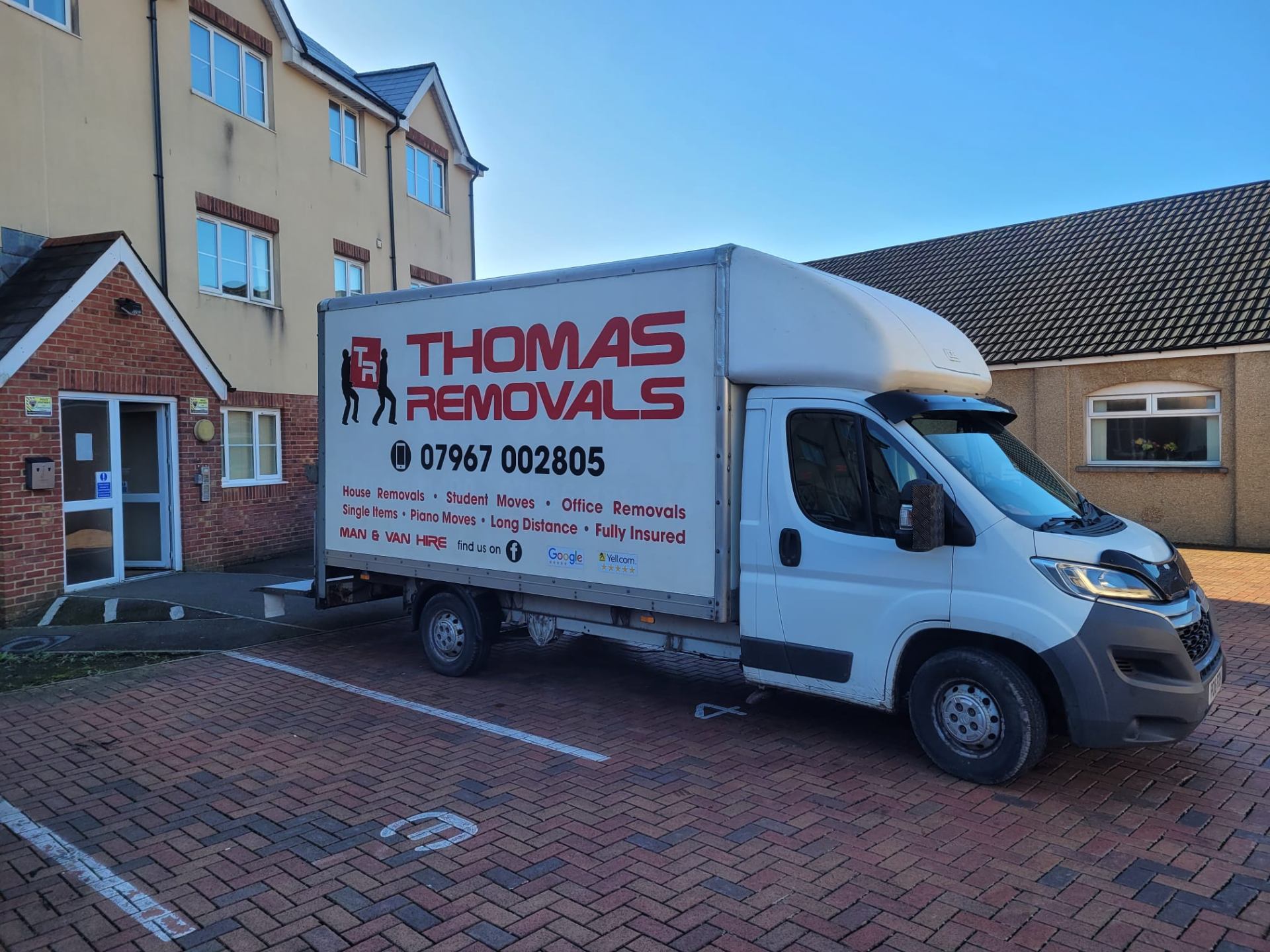 Thomas Removals van on a driveway completing a residential removal in South Wales