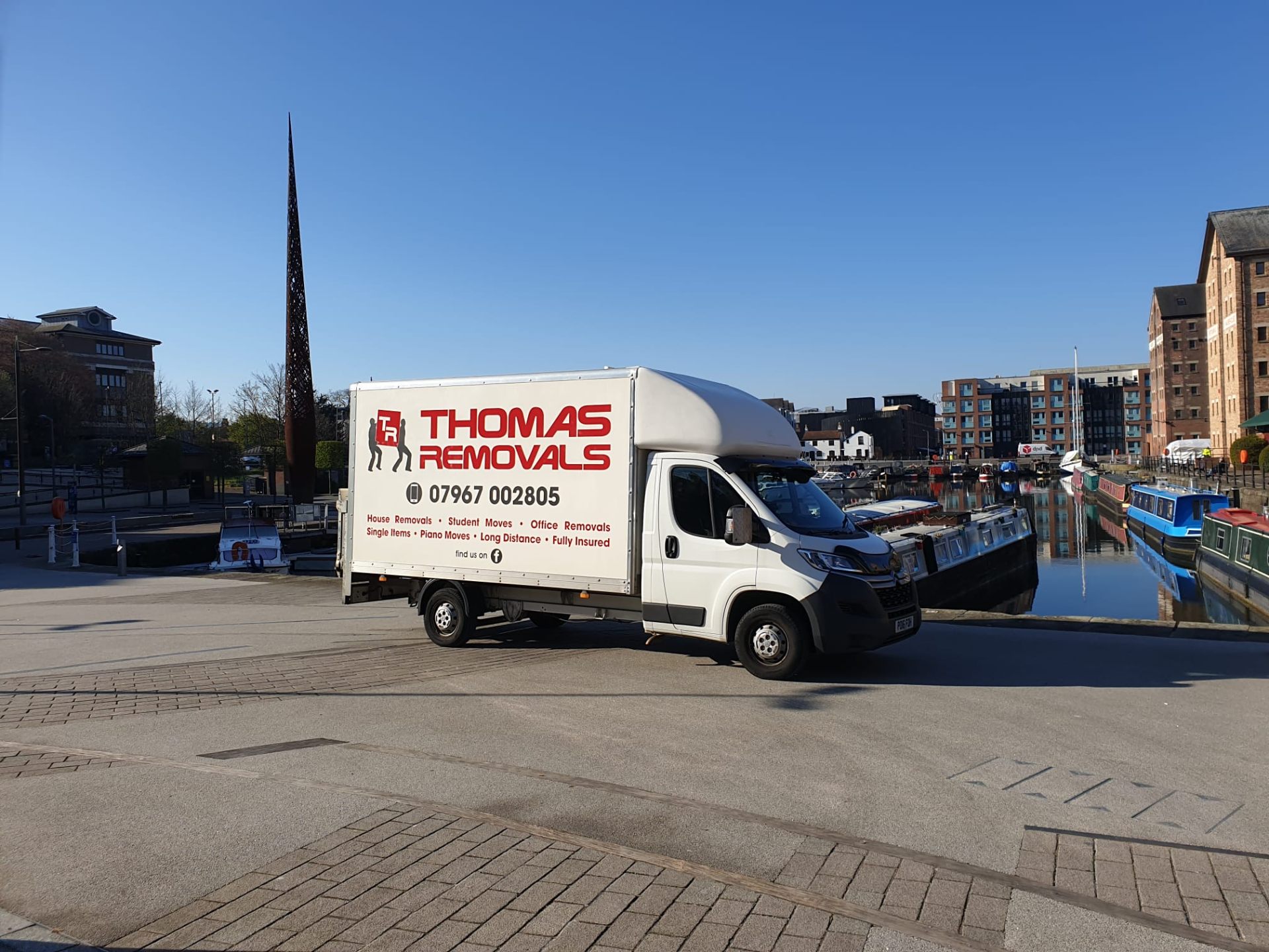 Thomas Removals removal van at a waterfront location in Gloucester during a long-distance move