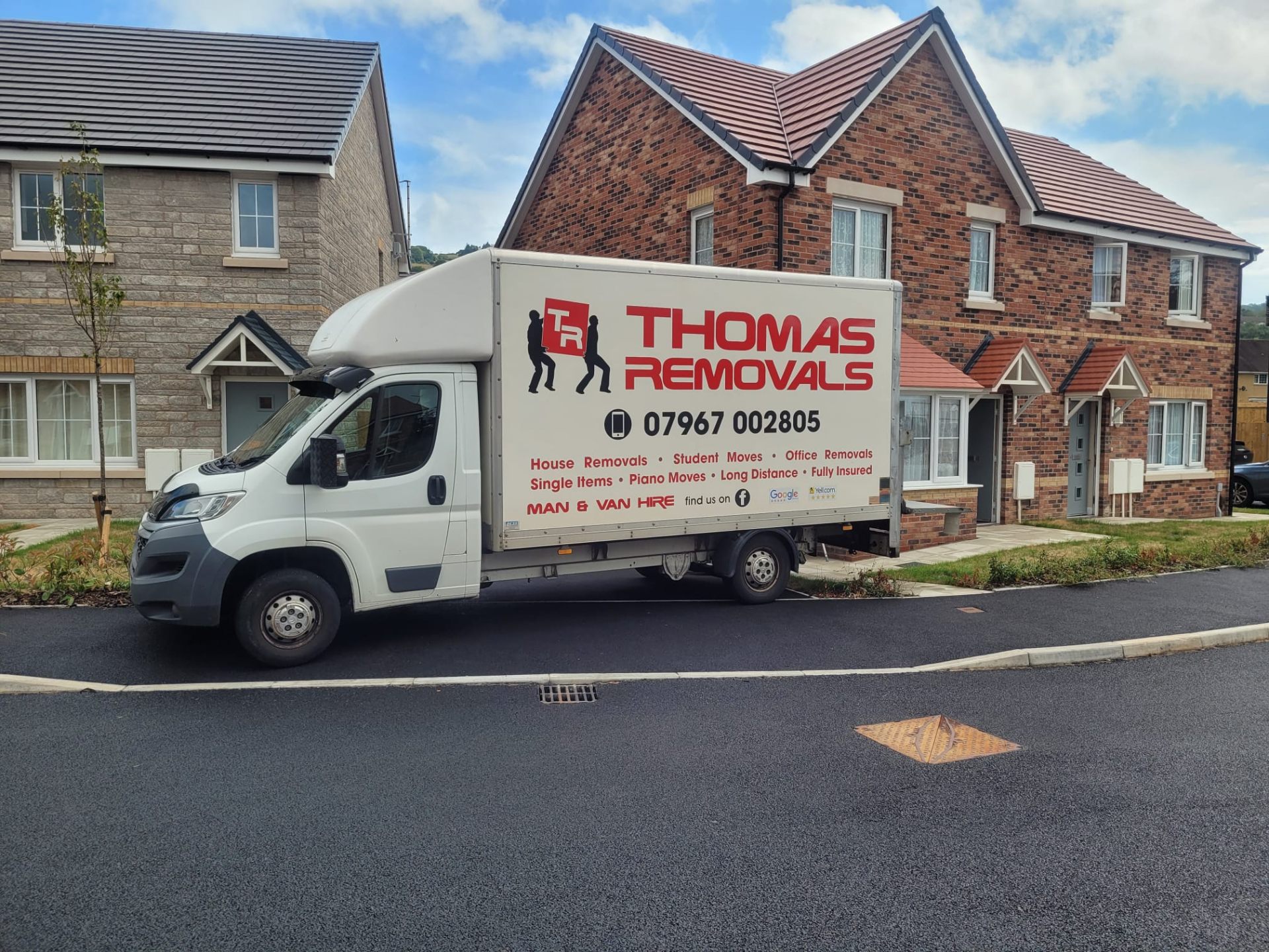 Thomas Removals van parked outside a new-build house in Rhondda Cynon Taff