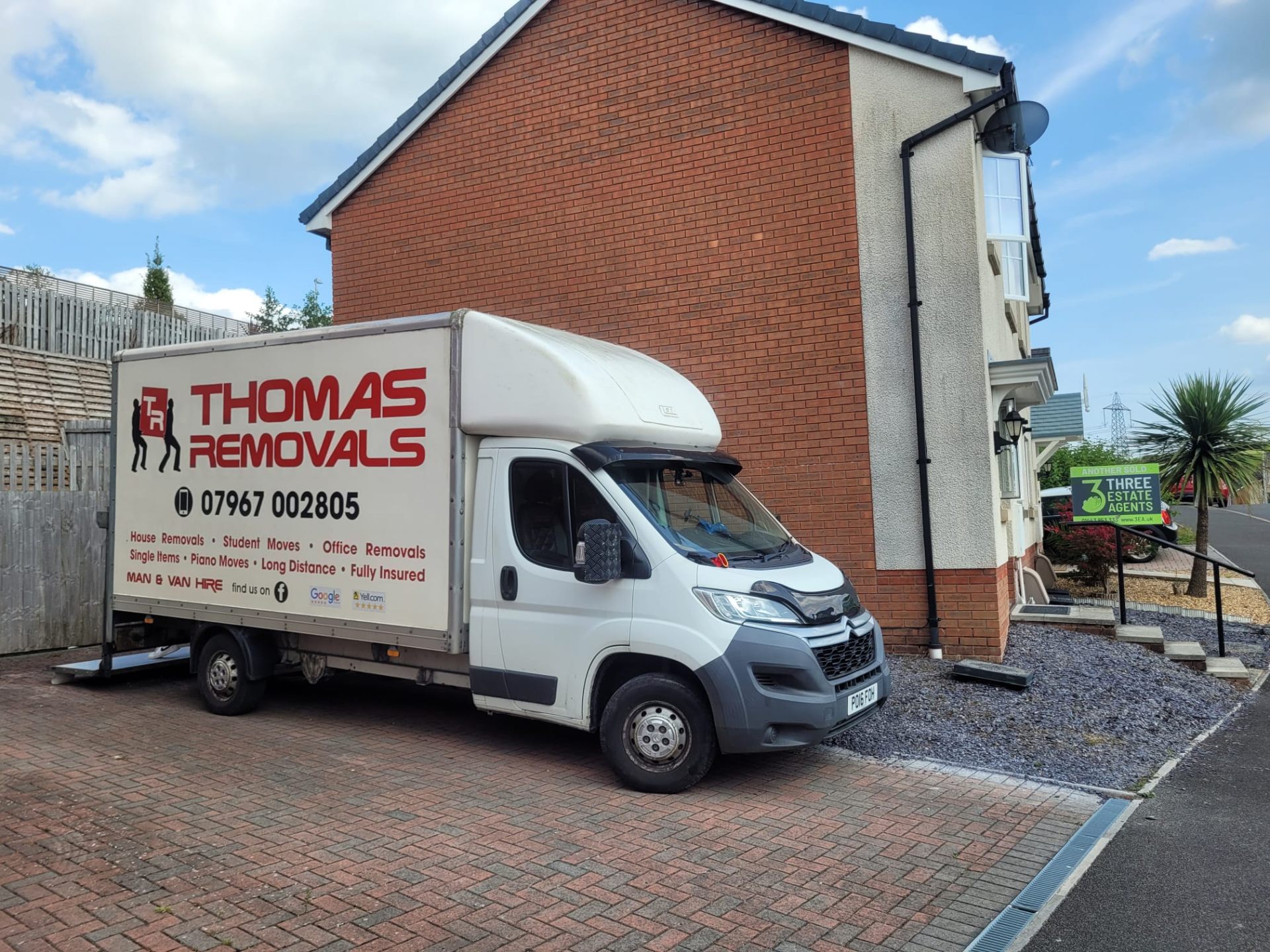 Thomas Removals van at a new-build estate completing a residential move