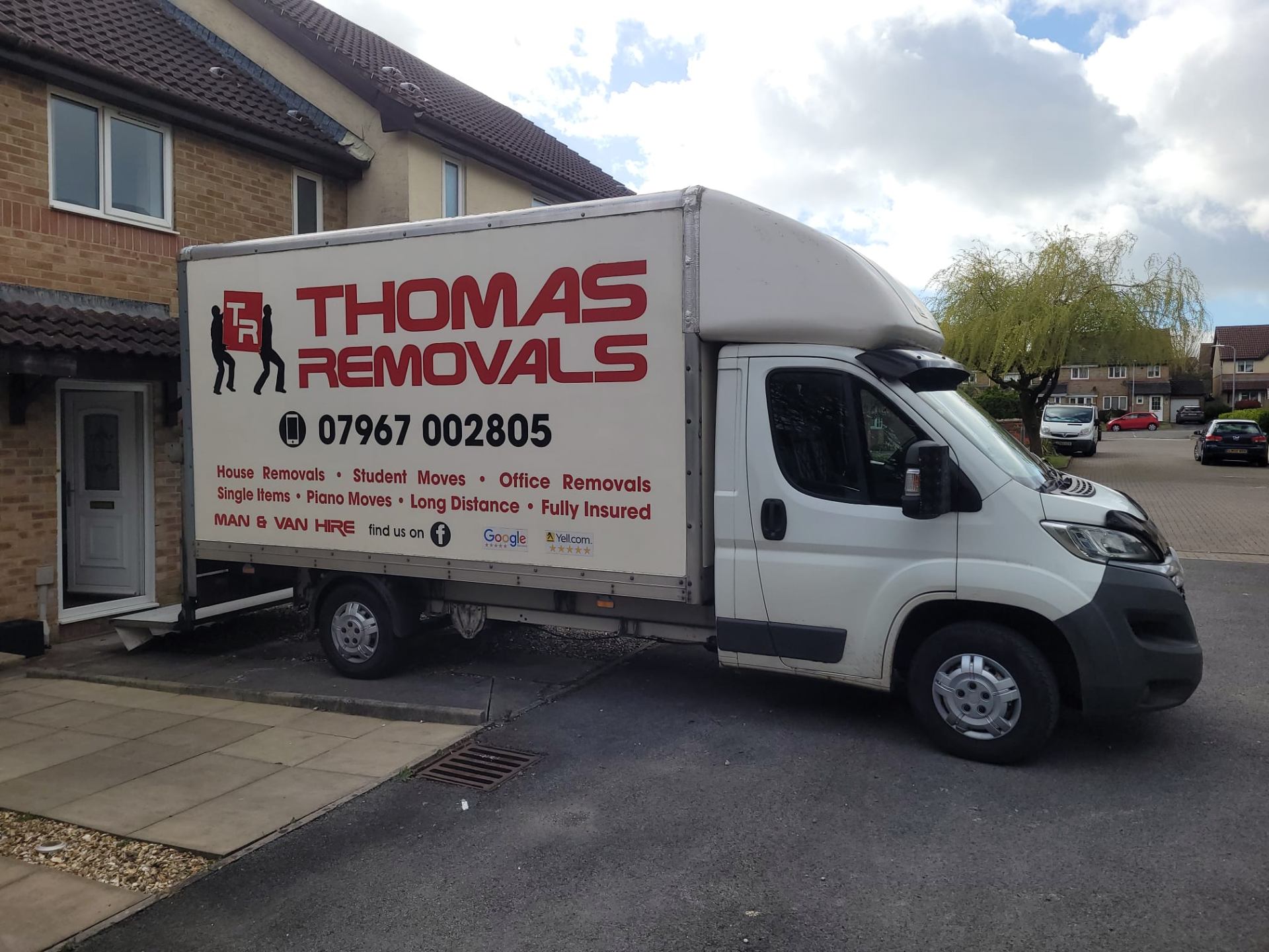 Thomas Removals van parked outside a semi-detached home during a local move